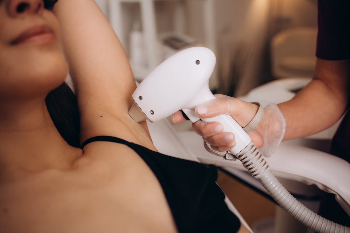 Laser hair removal treatment on underarm at beauty clinic
