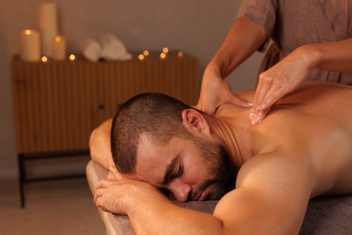 Relaxing neck massage, healthy massaging rehab concept. Woman masseur doing wellness medical relaxing massage for male patient