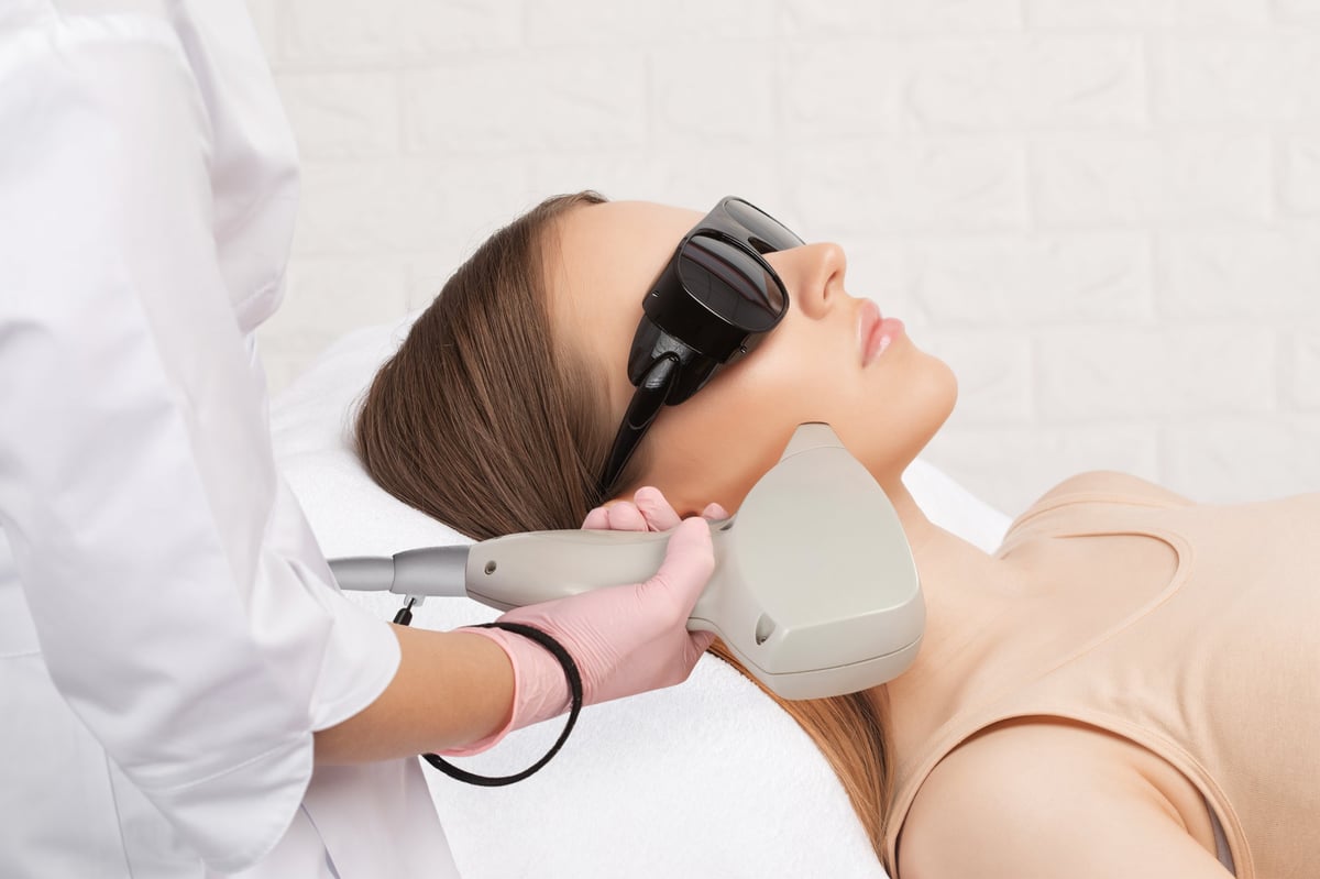Elos IPL laser hair removal procedure on woman at beauty clinic - professional depilation treatment